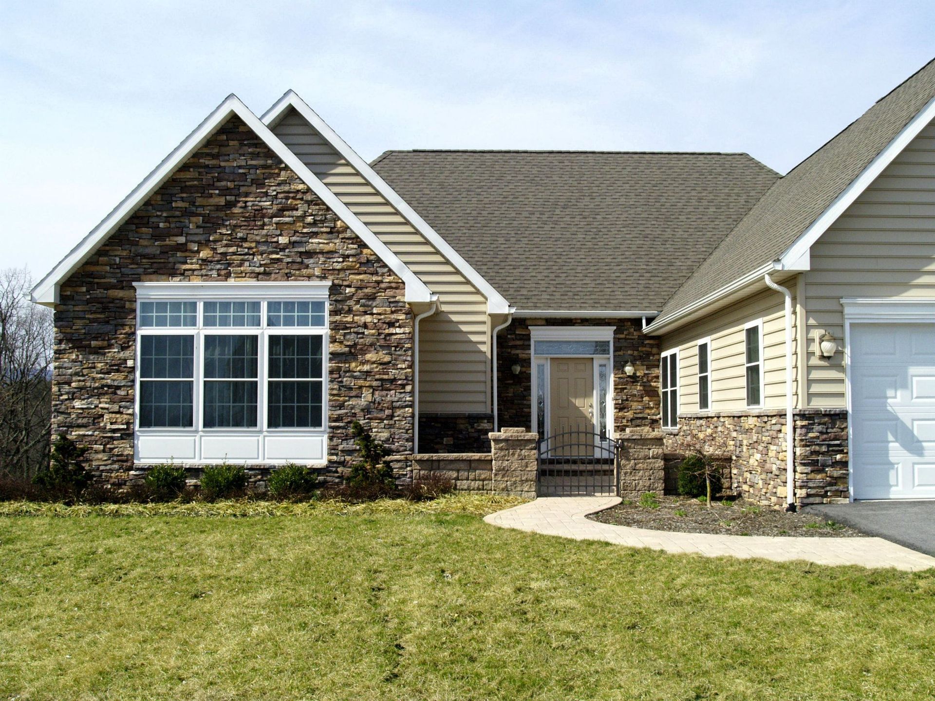 A House with A Stone Facade and A White Garage Door