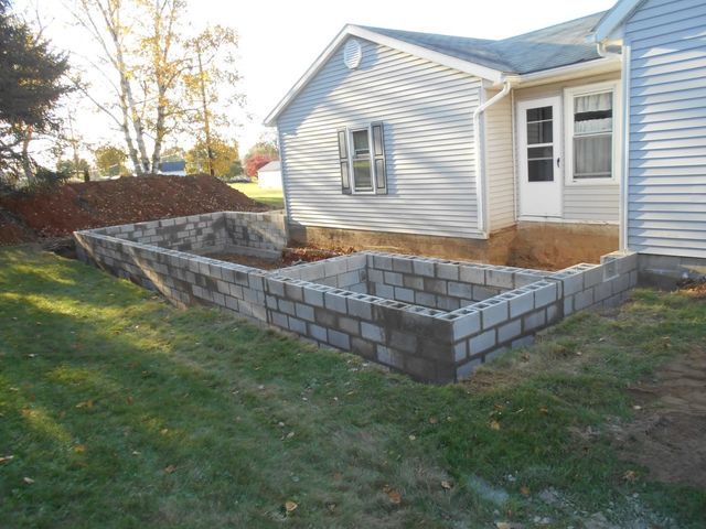 A Brick Wall Is Being Built in Front of A House
