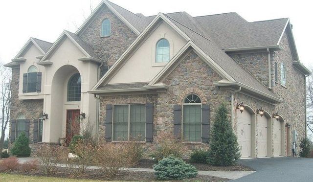 A Large House with A Lot of Windows and Garages