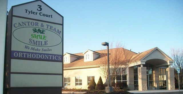 A Sign for Cantor & Team Orthodontics Is in Front of A Building