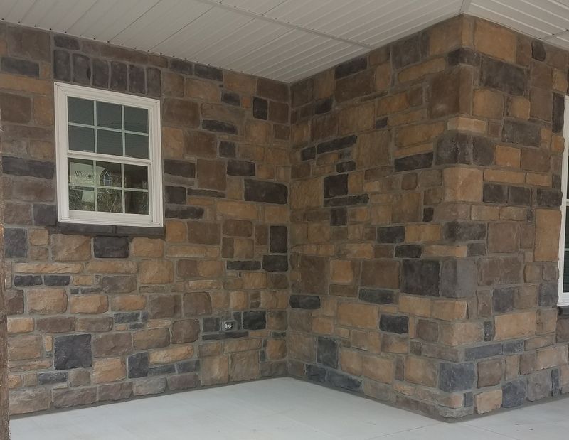 A Stone Wall with Two Windows on It