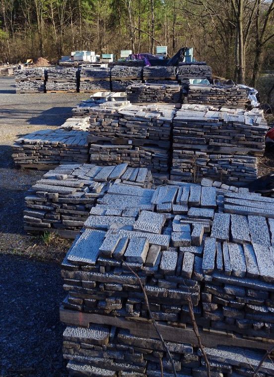 A Bunch of Stacks of Rocks Are Sitting on The Ground