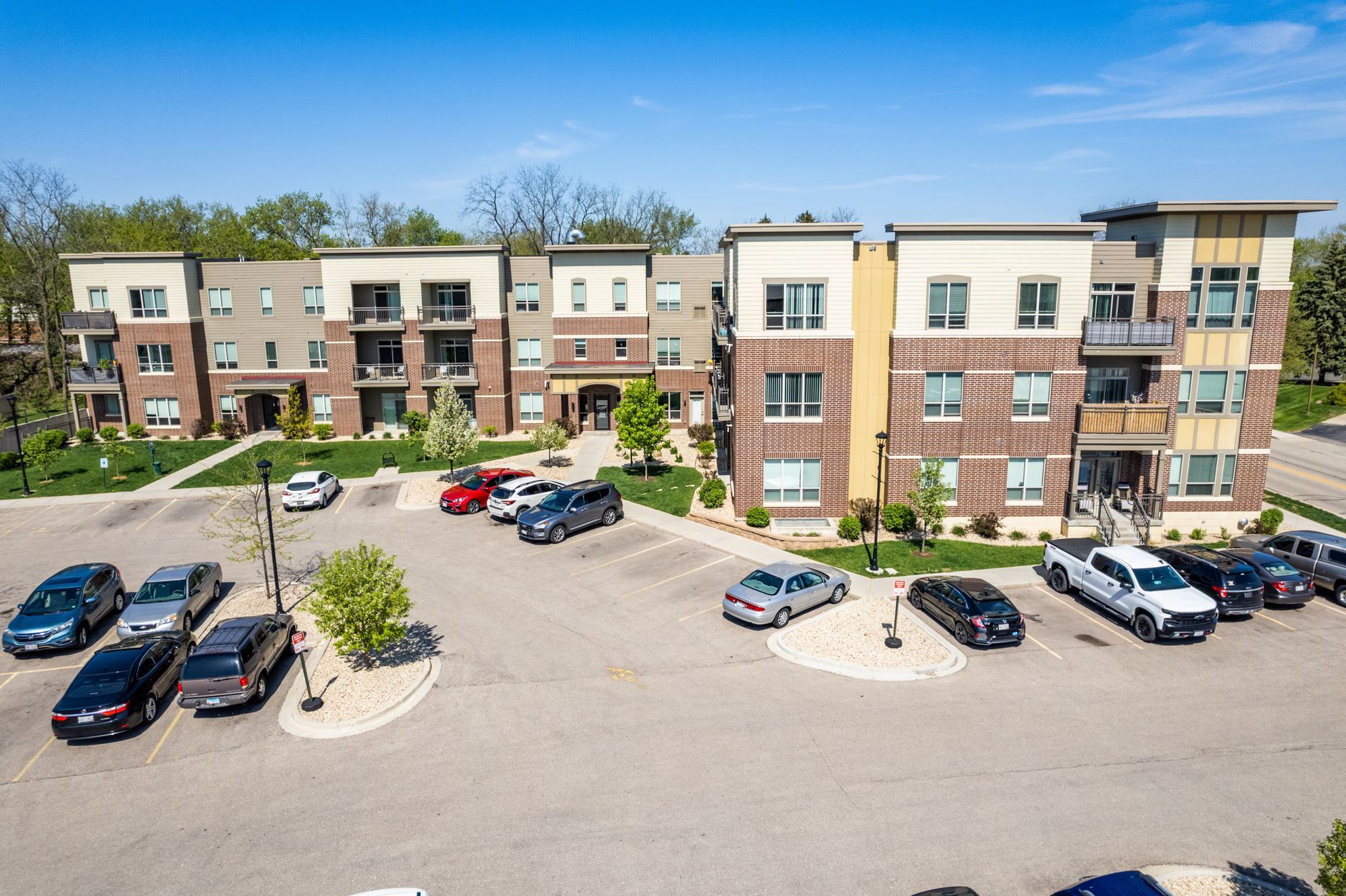 a large apartment building with cars parked in front of it