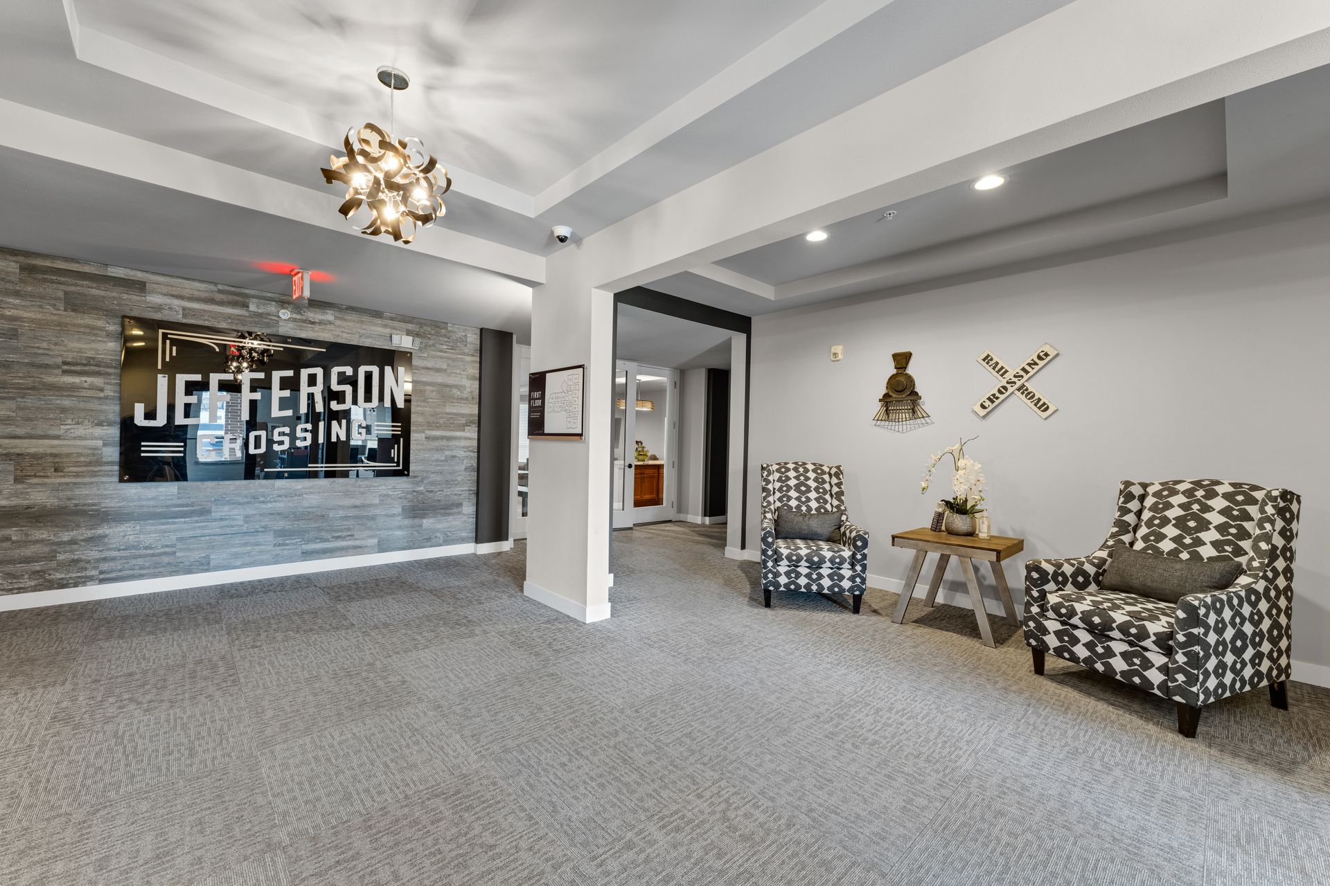 a room with two chairs and a sign that says jefferson crossing