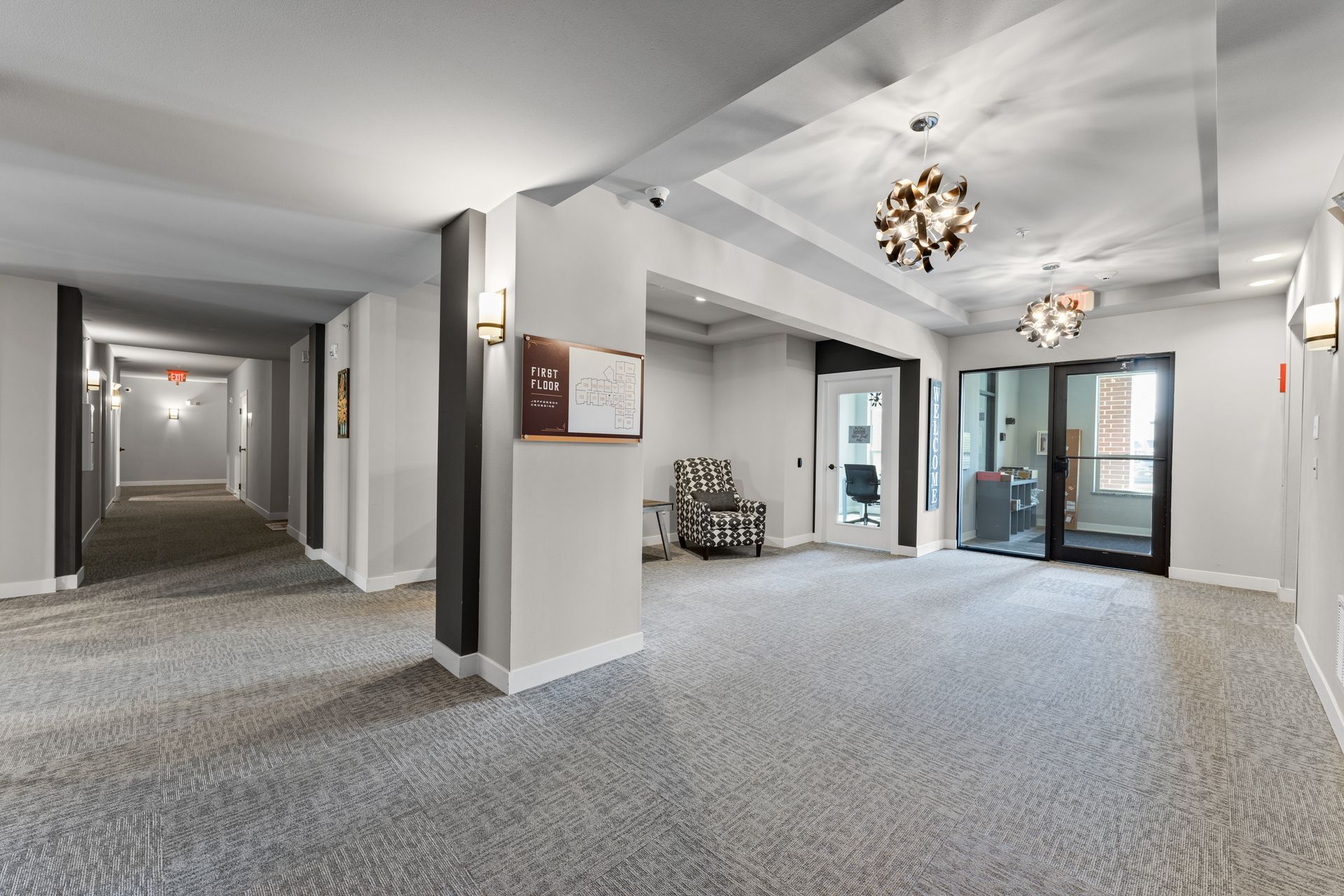 a hallway with a sign that says first floor