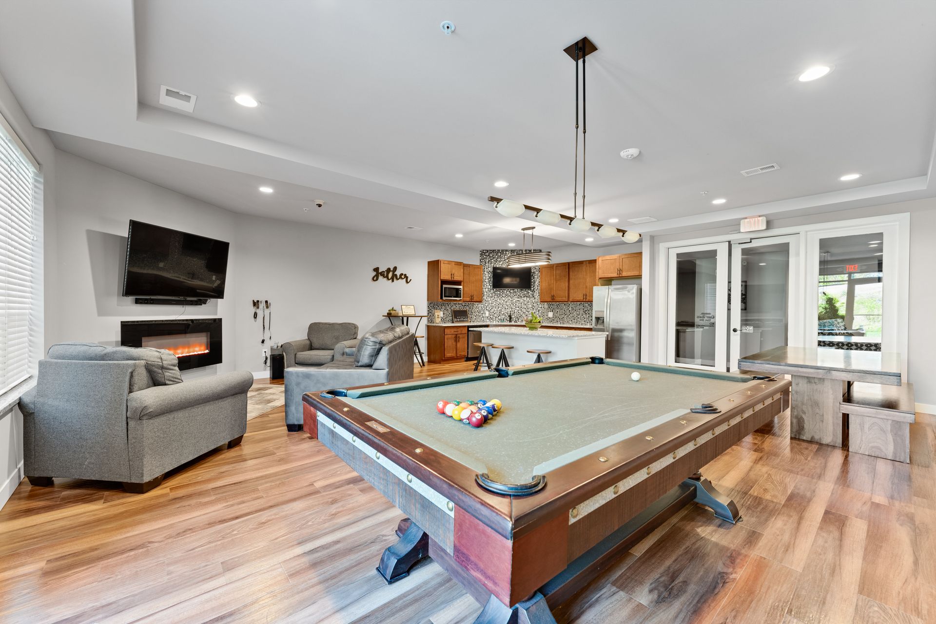 a pool table in a room with a sign that says sister