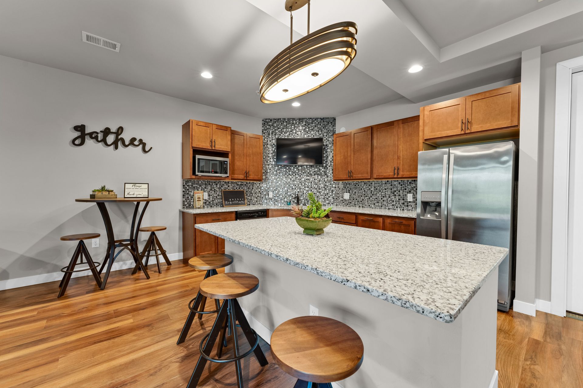 a kitchen with a sign that says gather on the wall