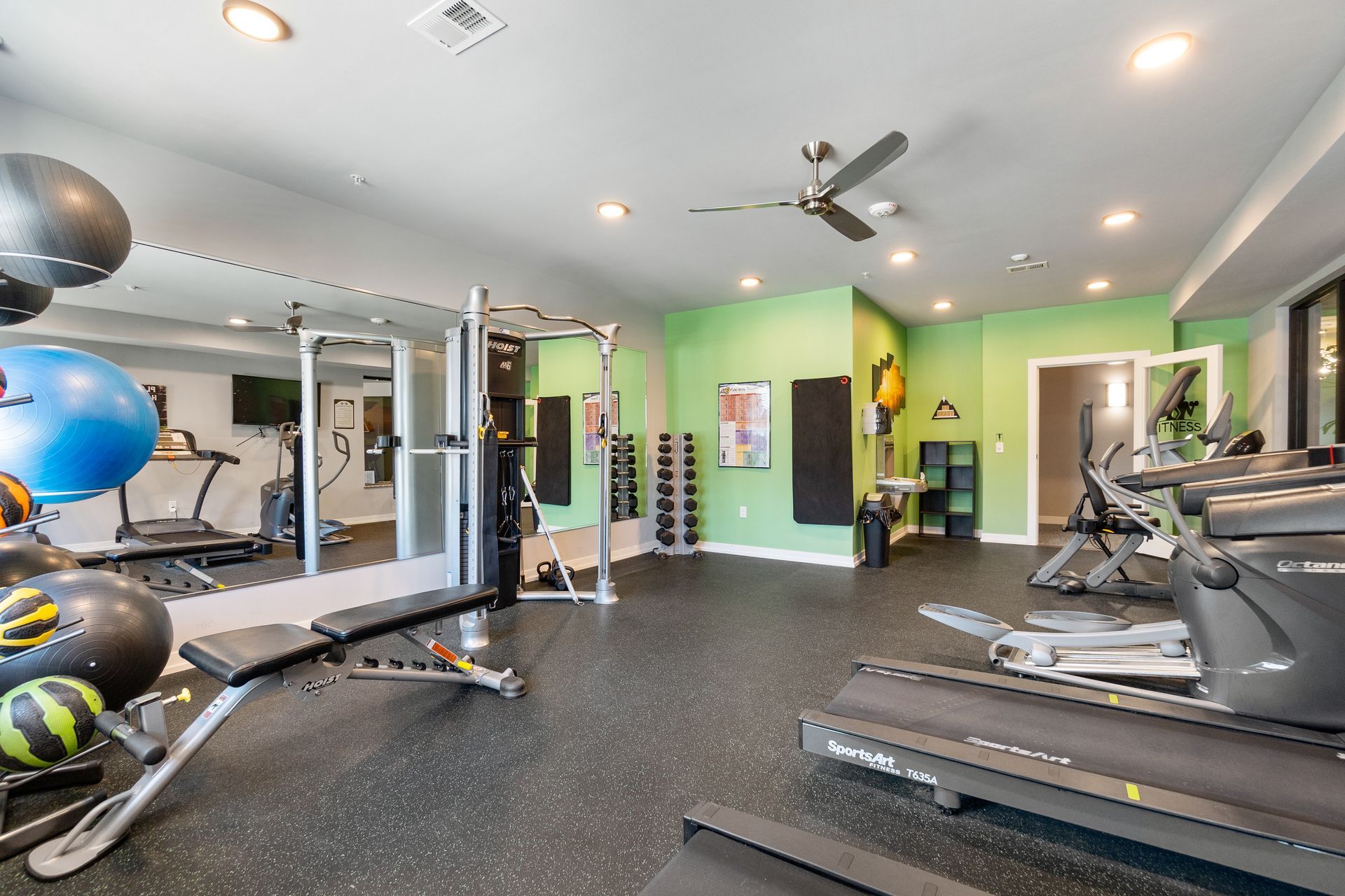 a gym with a treadmill that says reebok on it
