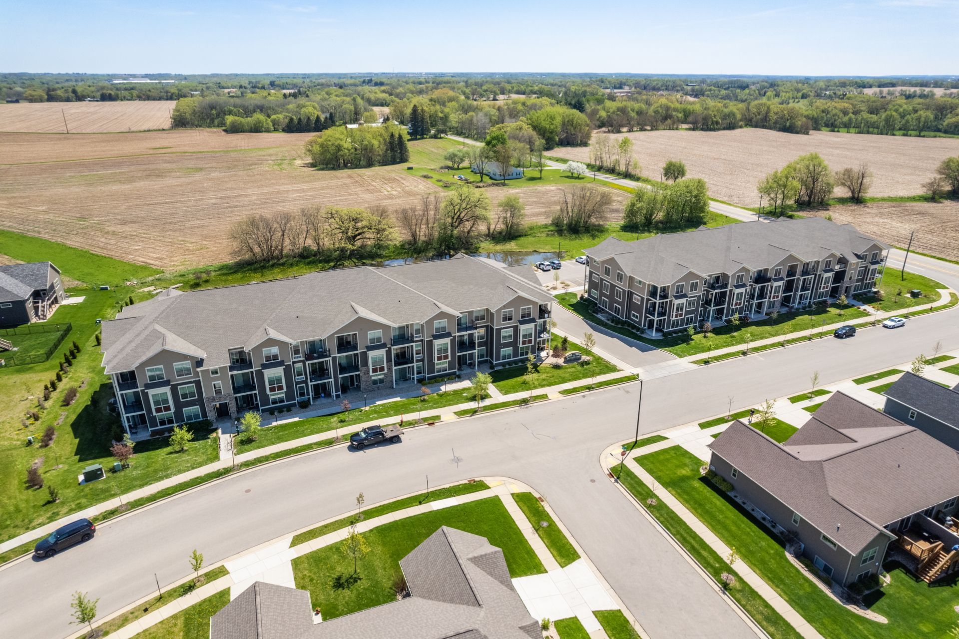 an aerial view of a residential area with a large apartment building in the middle
