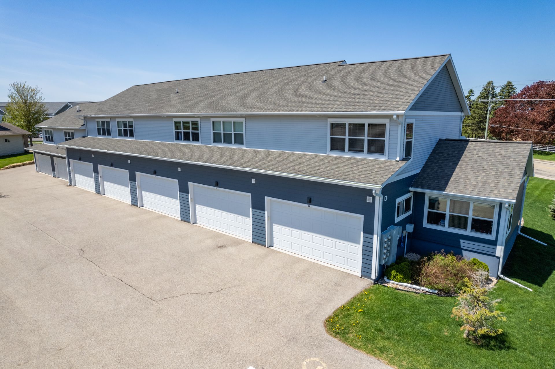 a blue and white house with a lot of garages