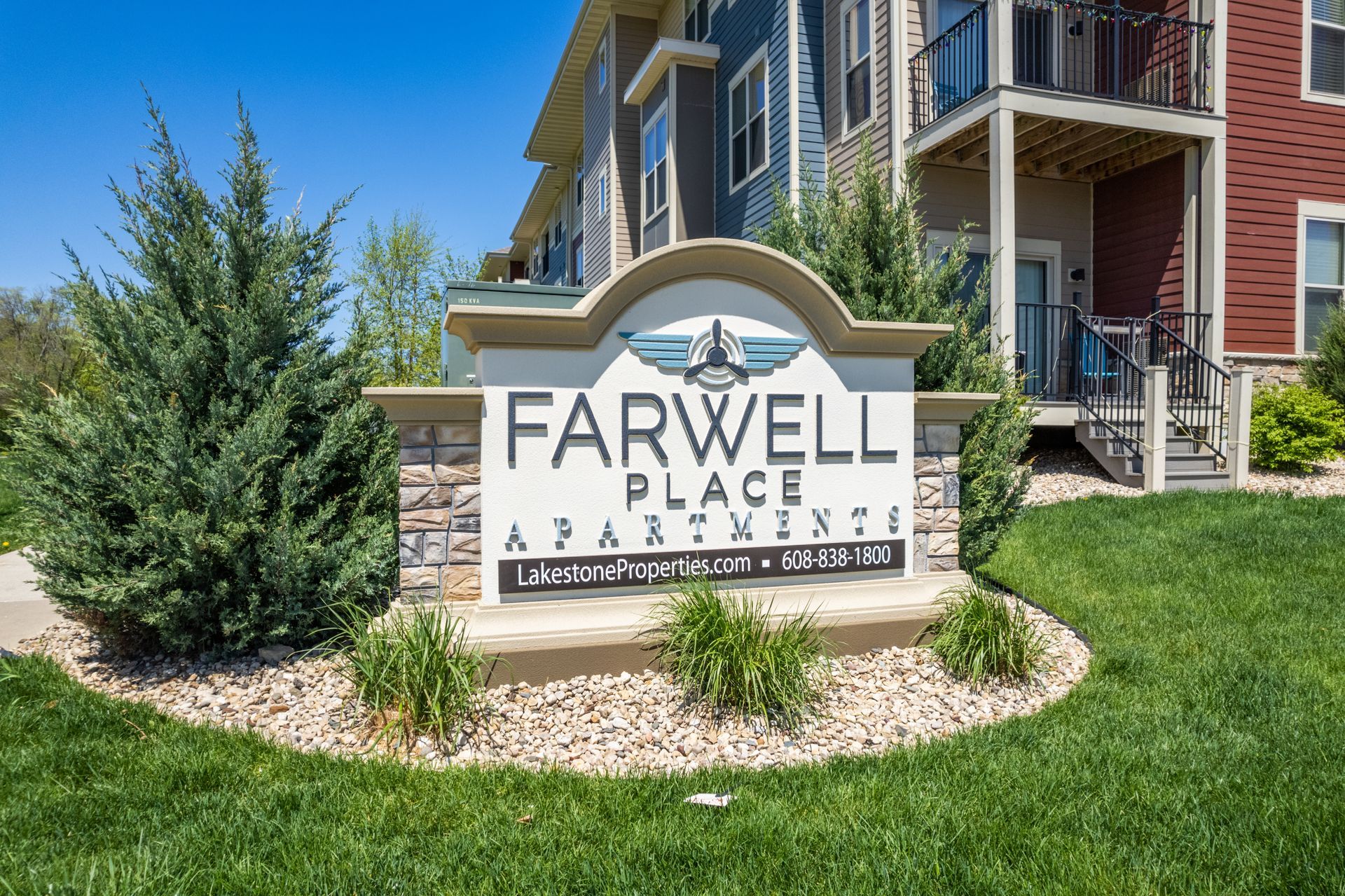a sign for farewell place apartments sits in front of a building