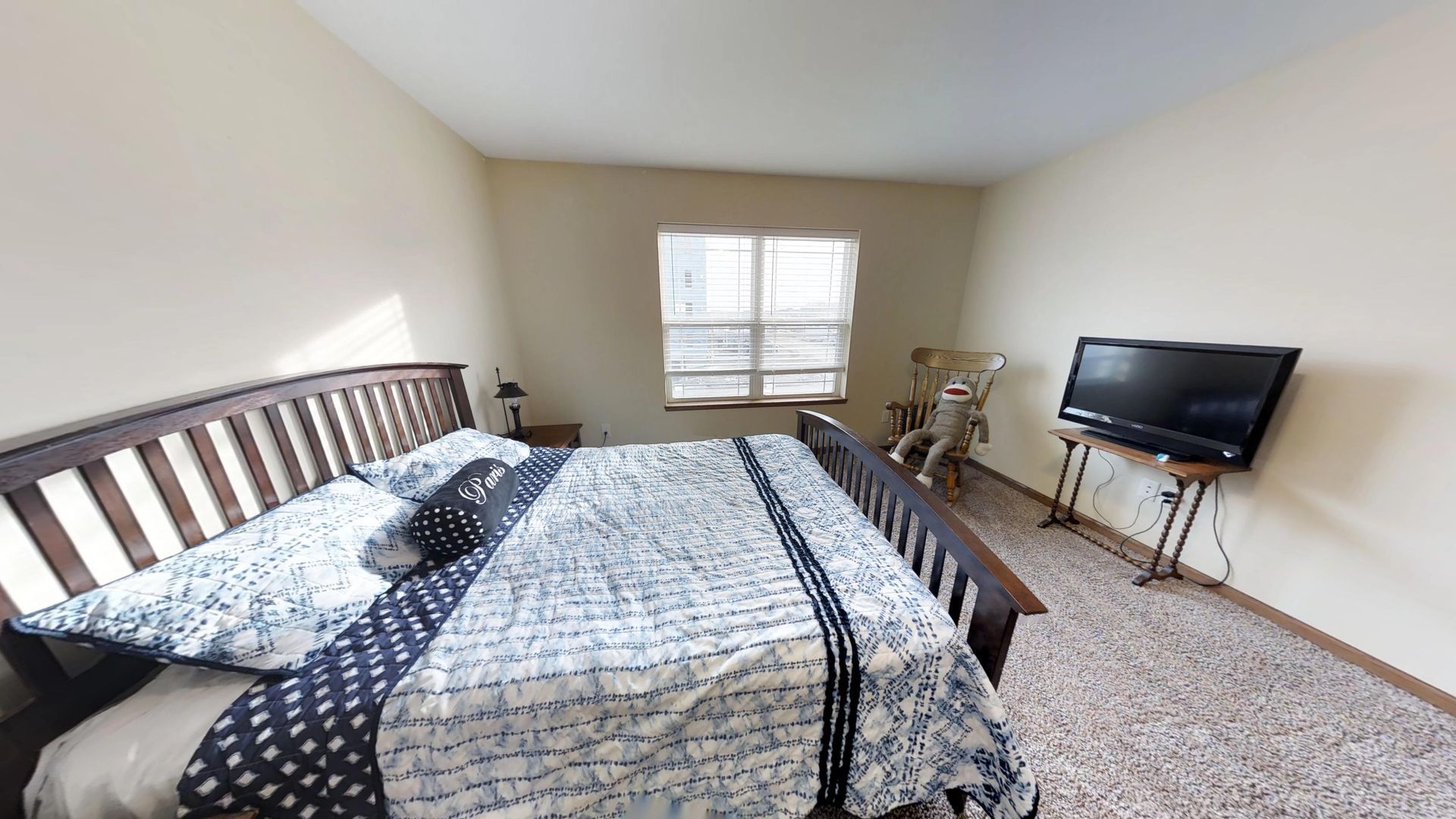 a bedroom with a king size bed and a television
