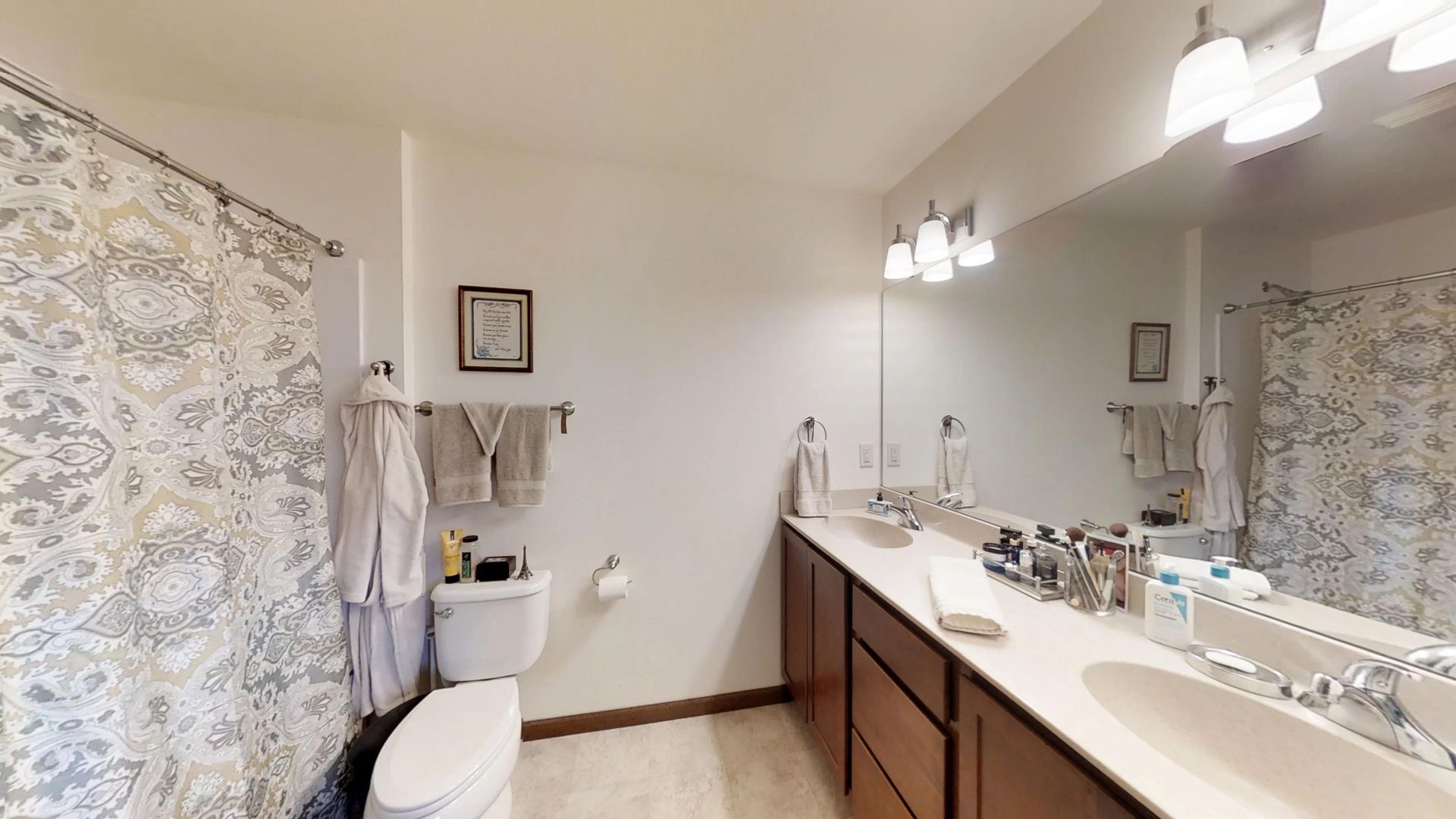 a bathroom with a toilet a sink and a mirror