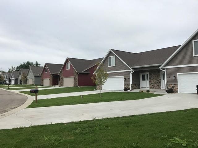 a row of houses with garages in a residential neighborhood .