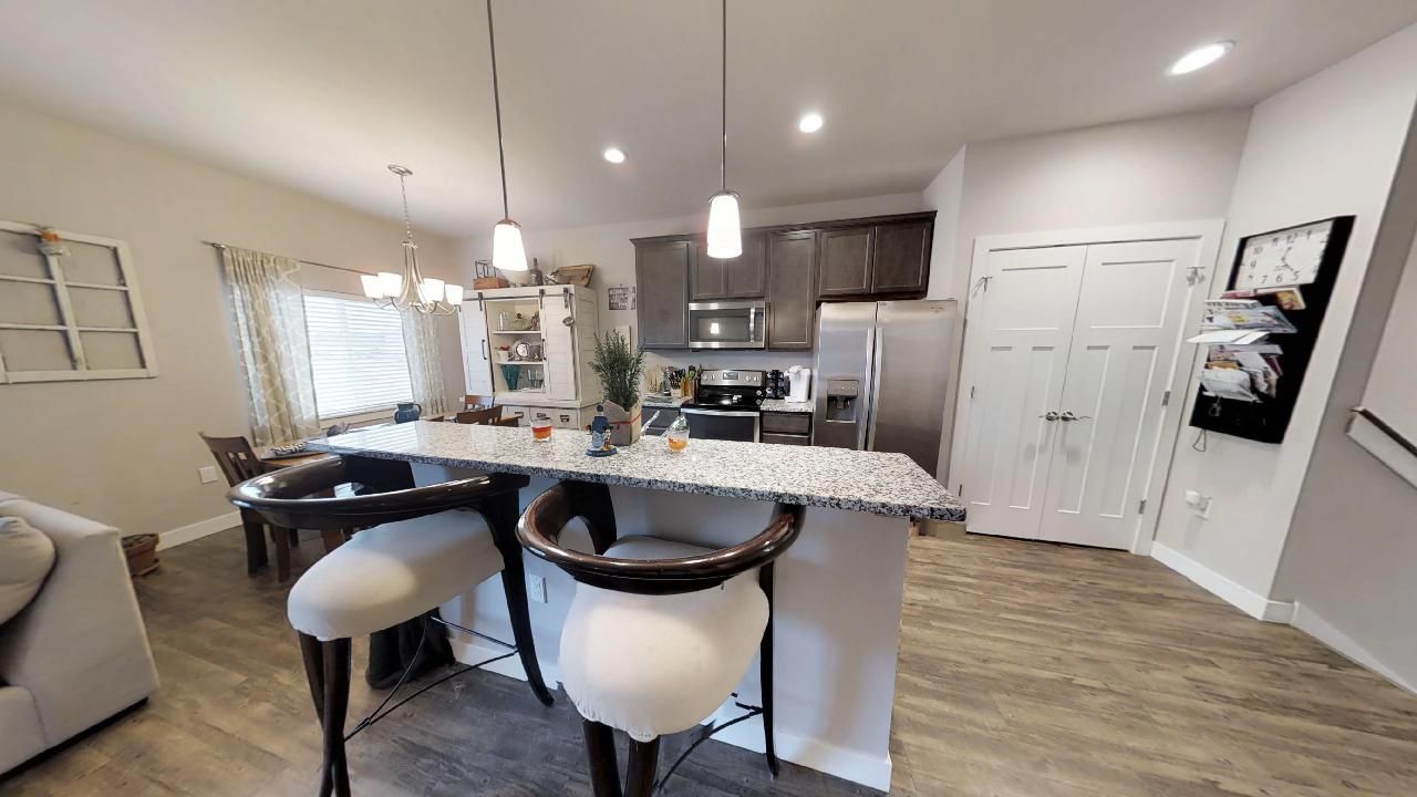 a kitchen with granite counter tops and stainless steel appliances