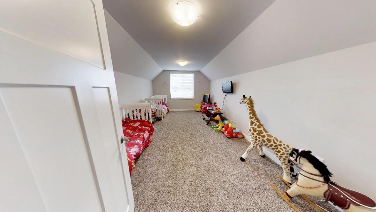a room with a giraffe and a rocking horse in it