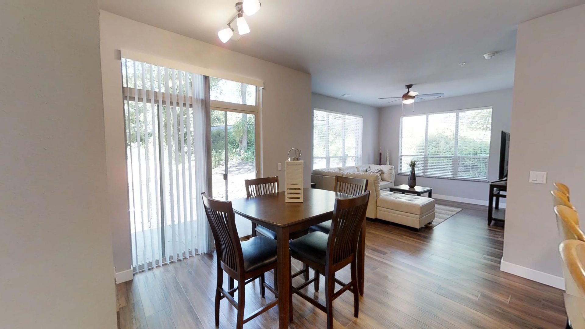 a living room with a table and chairs and a sliding glass door