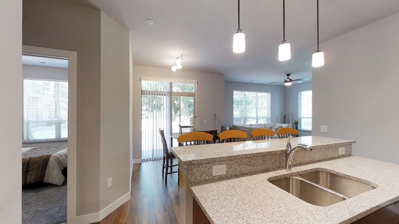 a kitchen with granite counter tops and a stainless steel sink