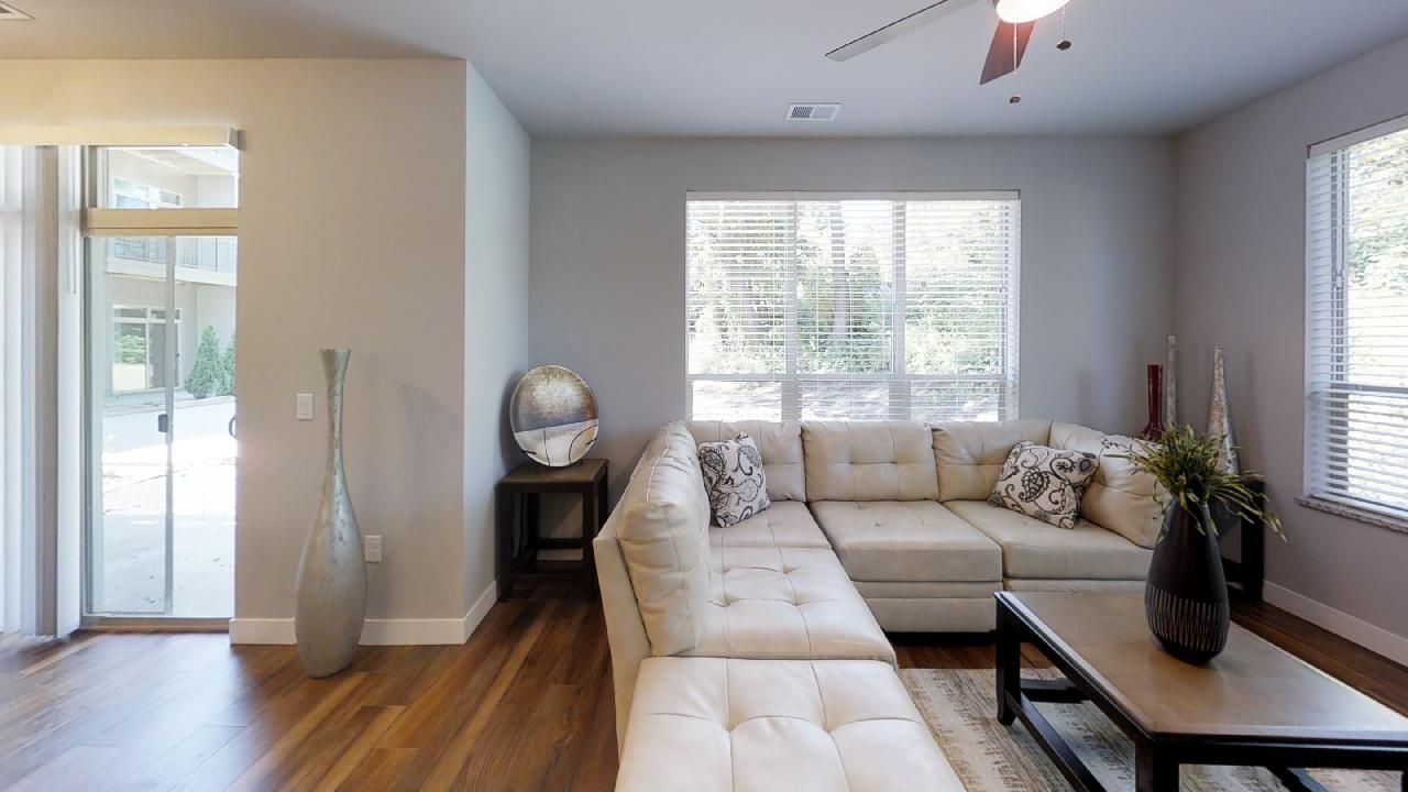a living room with a sectional couch and a coffee table