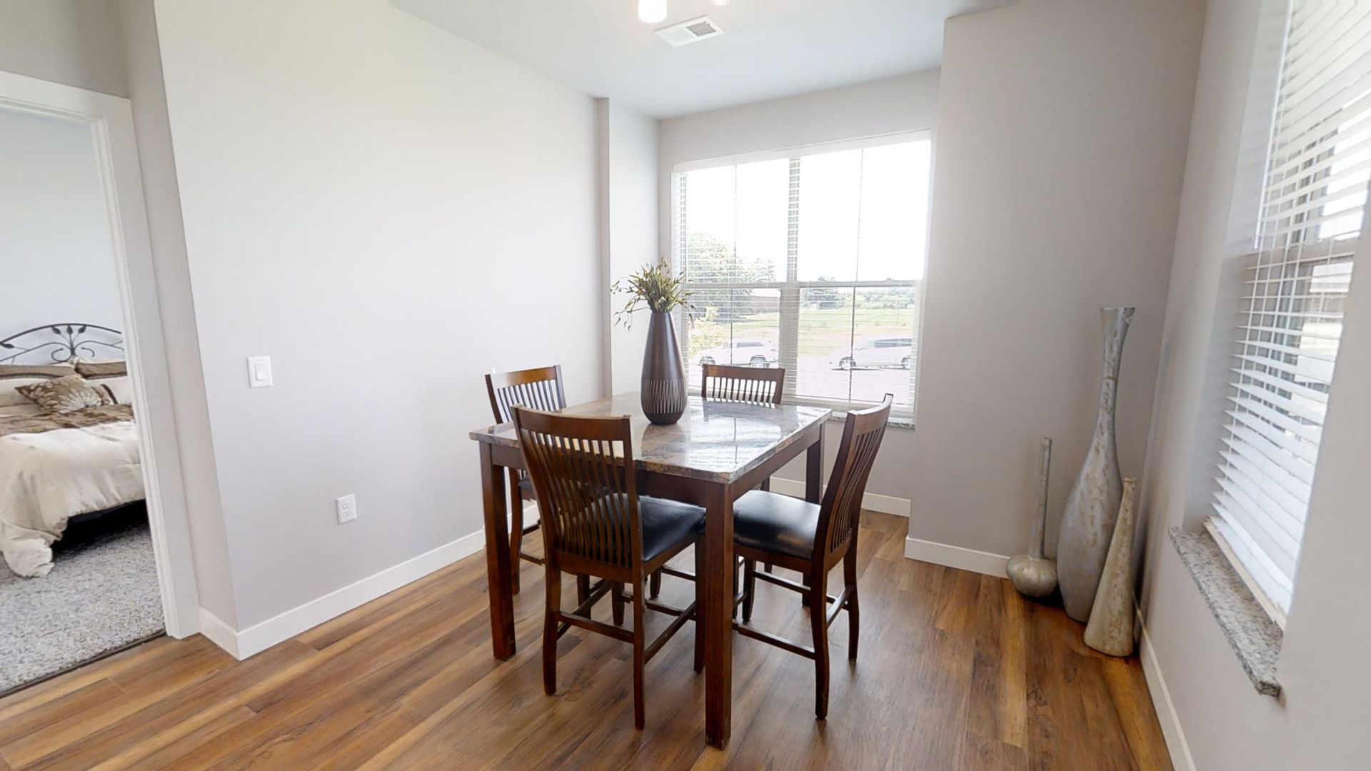 a dining room with a table and chairs and a window