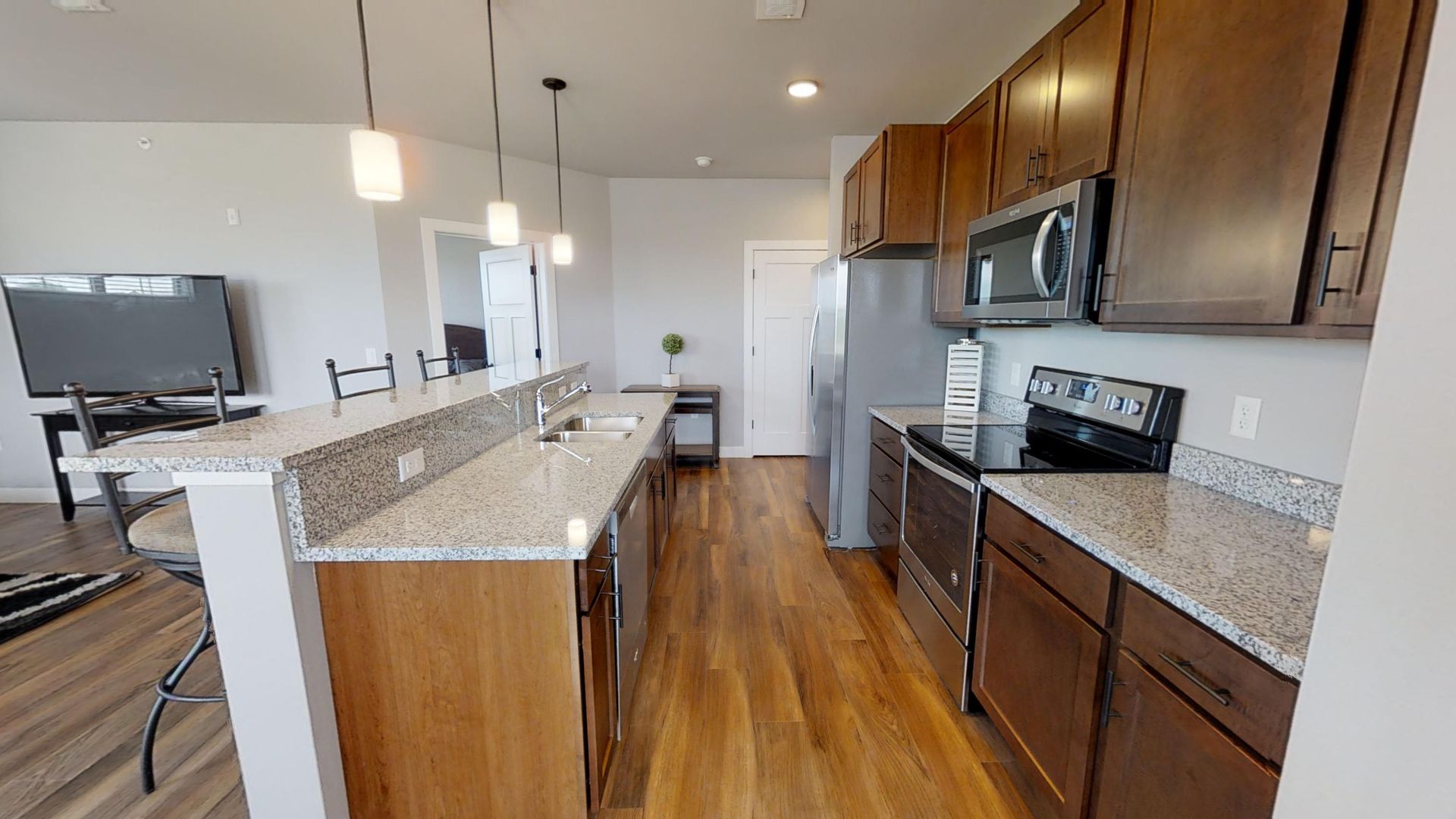 a kitchen with granite counter tops and stainless steel appliances