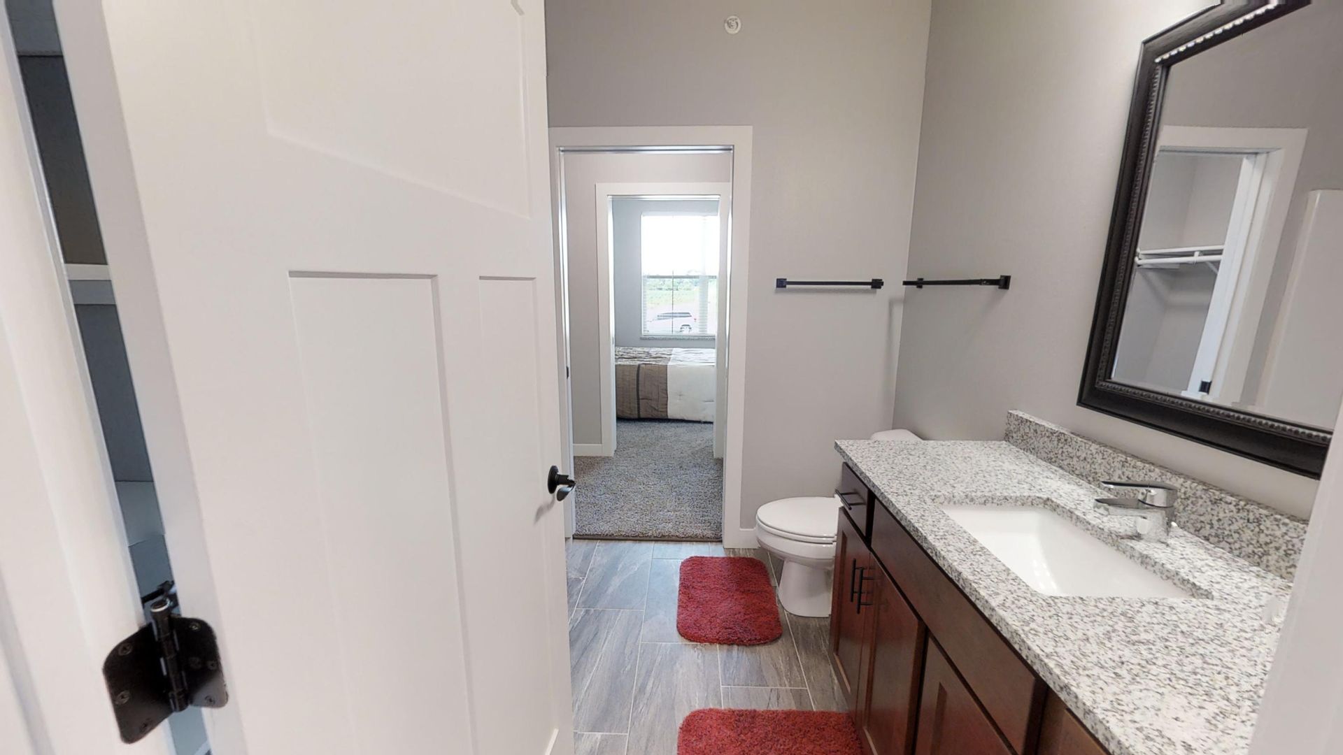 a bathroom with a toilet a sink and a mirror
