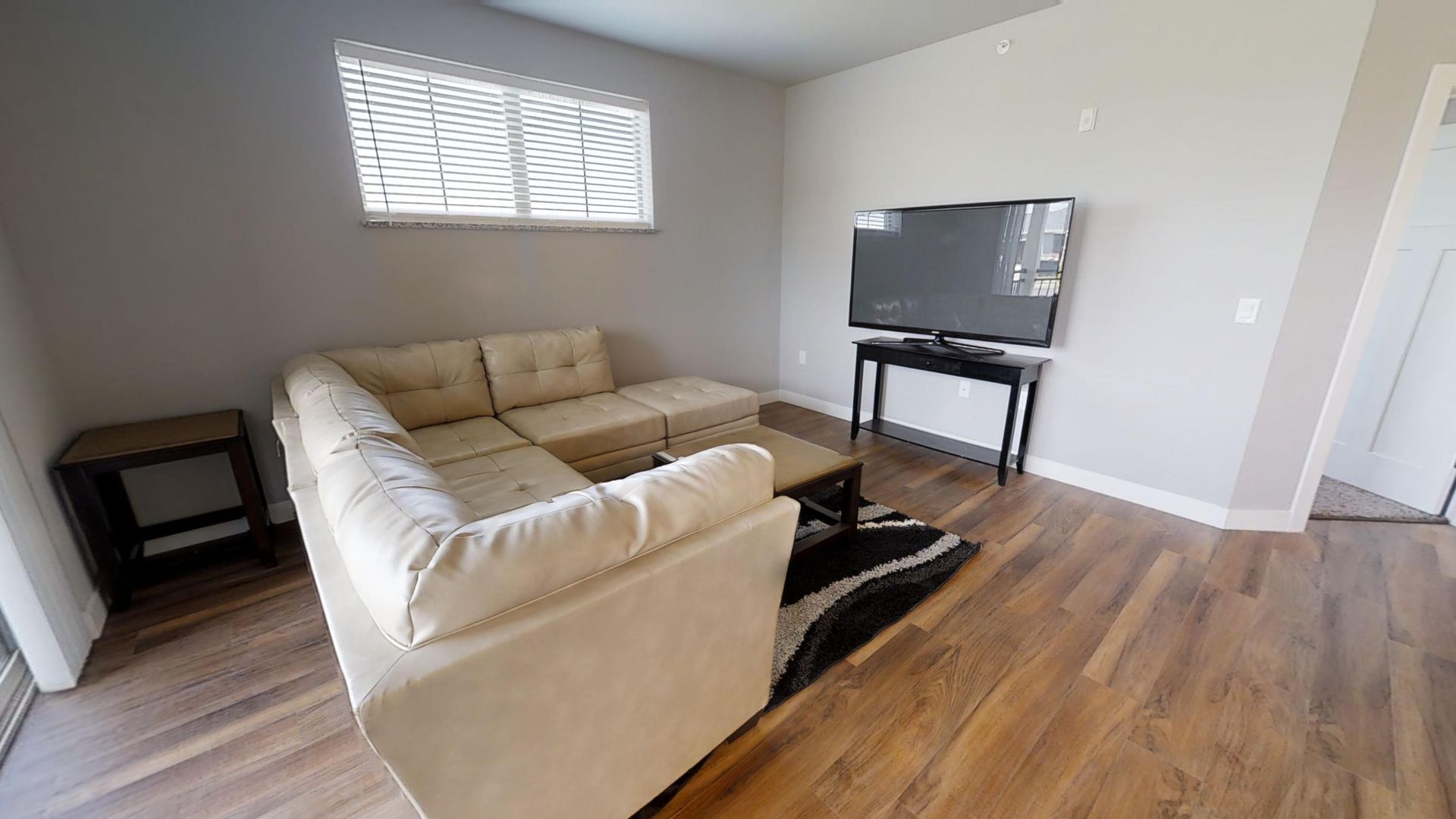 a living room with a couch and a flat screen tv