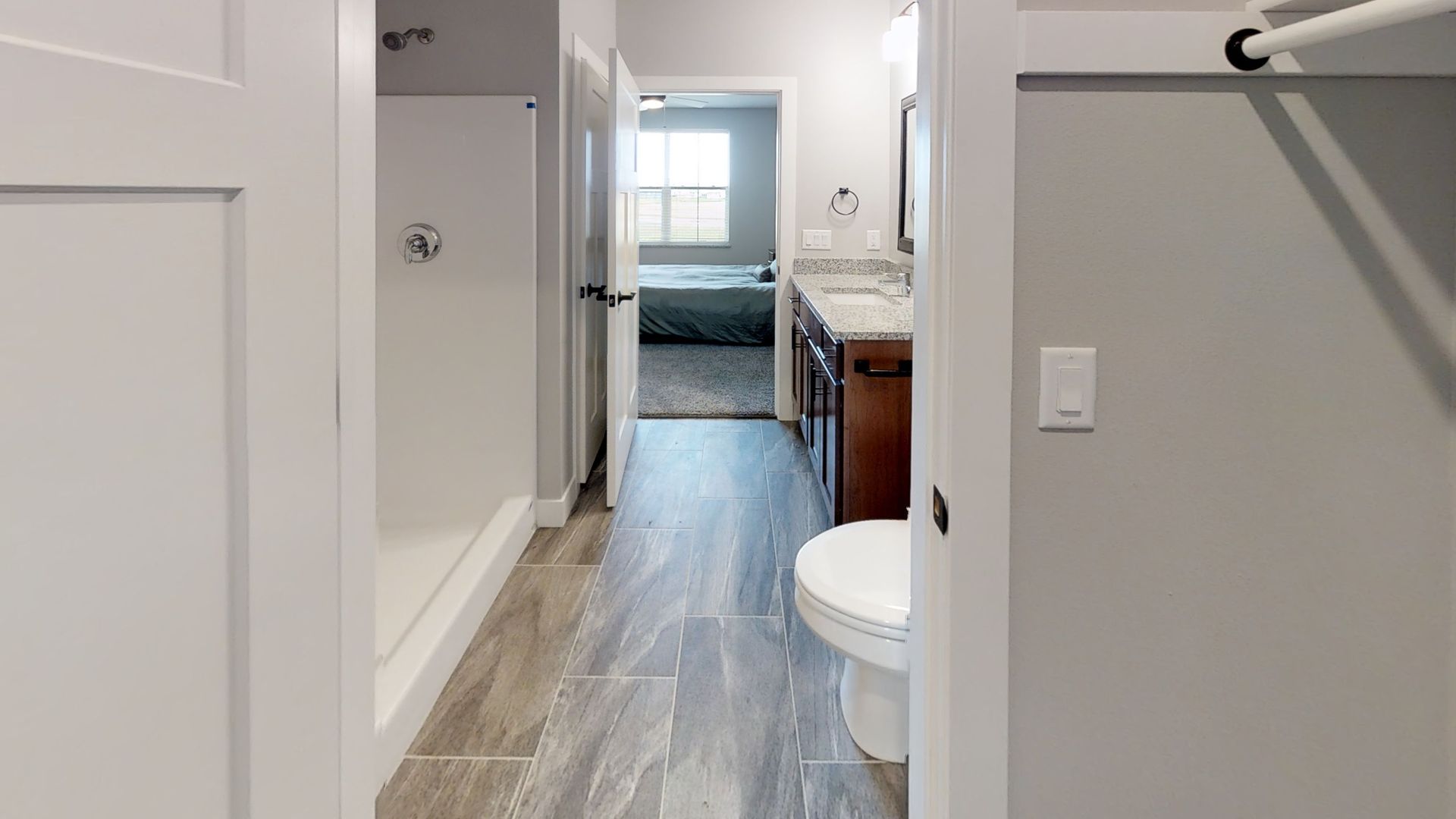 a bathroom with a toilet a sink and a walk in shower