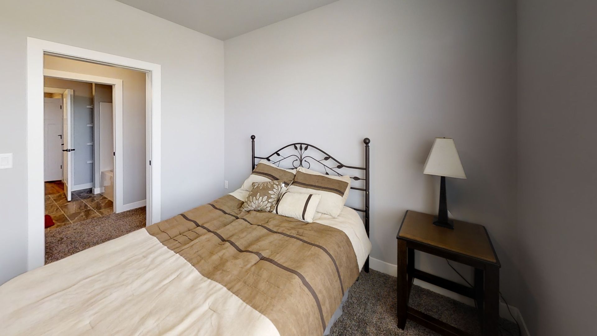 a bedroom with a single bed and a lamp