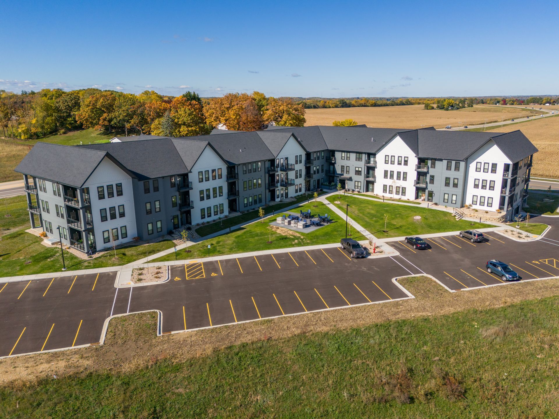 a large apartment building with a parking lot in front of it