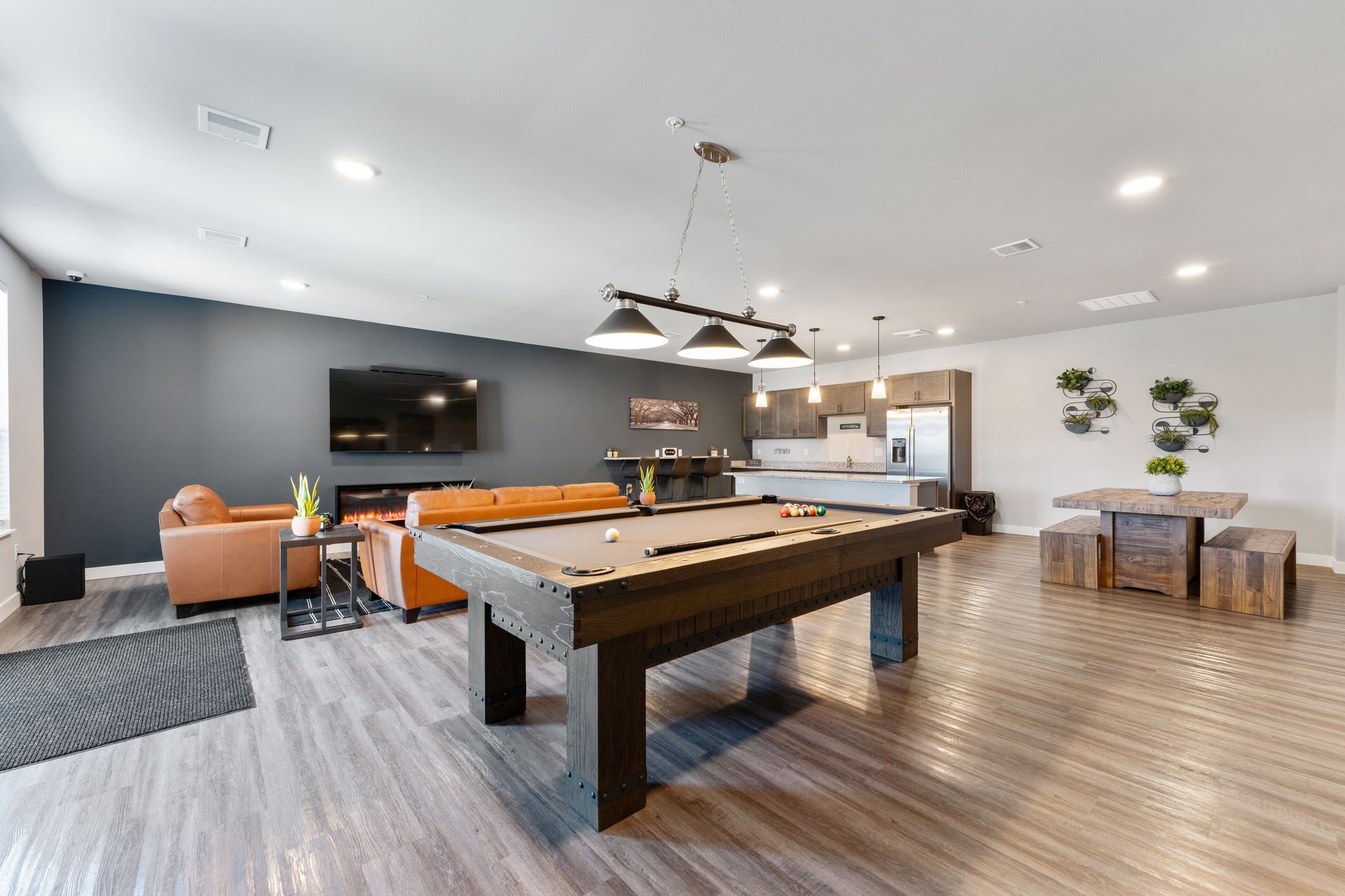 a pool table is in the middle of a living room
