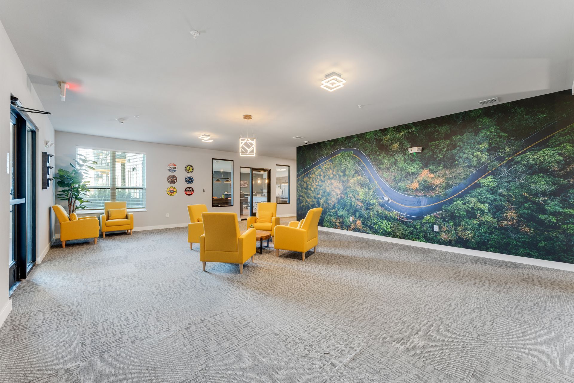a room with chairs and a wall with a picture of a road