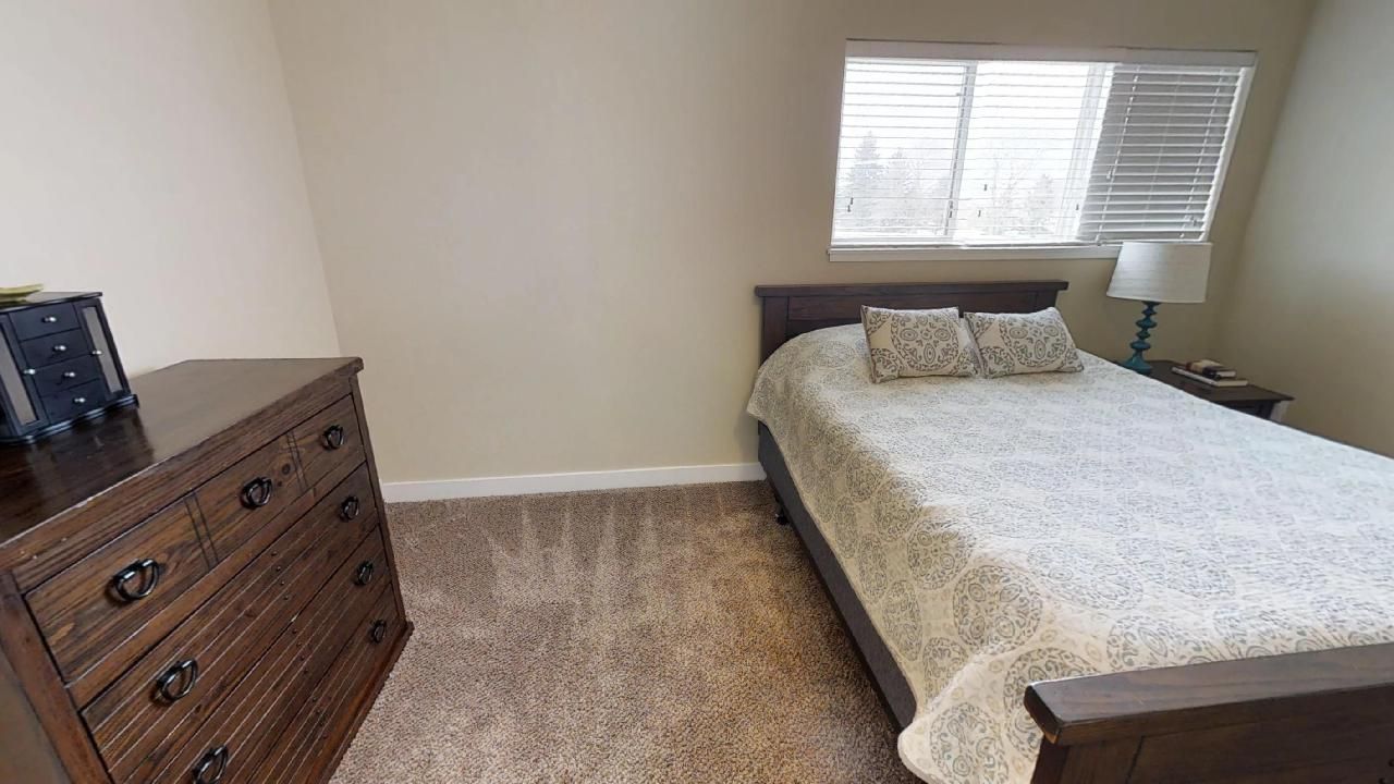 a bedroom with a single bed and a dresser