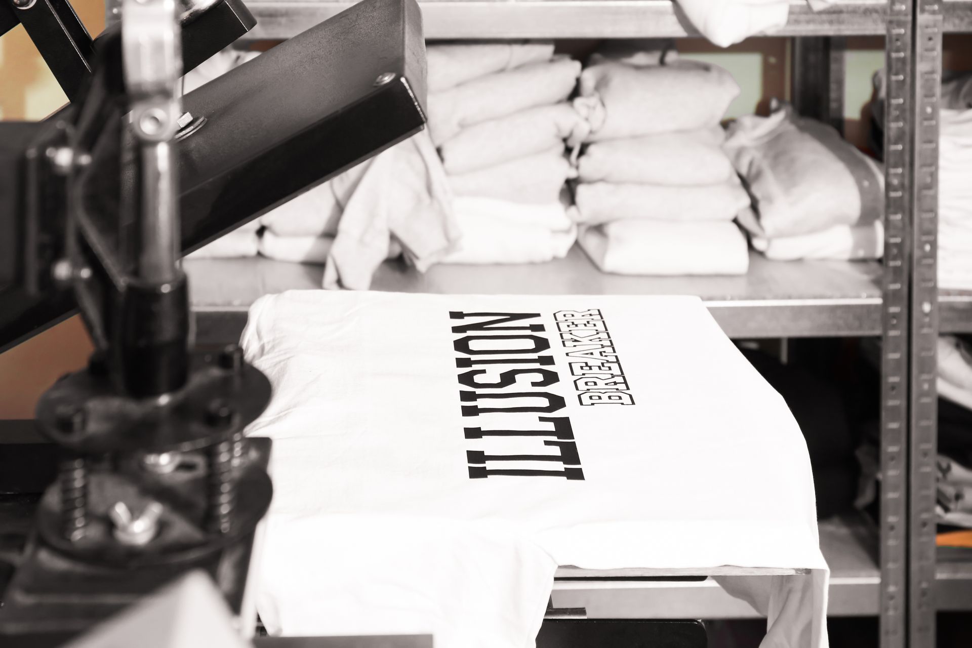 A heat press machine stamping a custom design onto a white t-shirt.