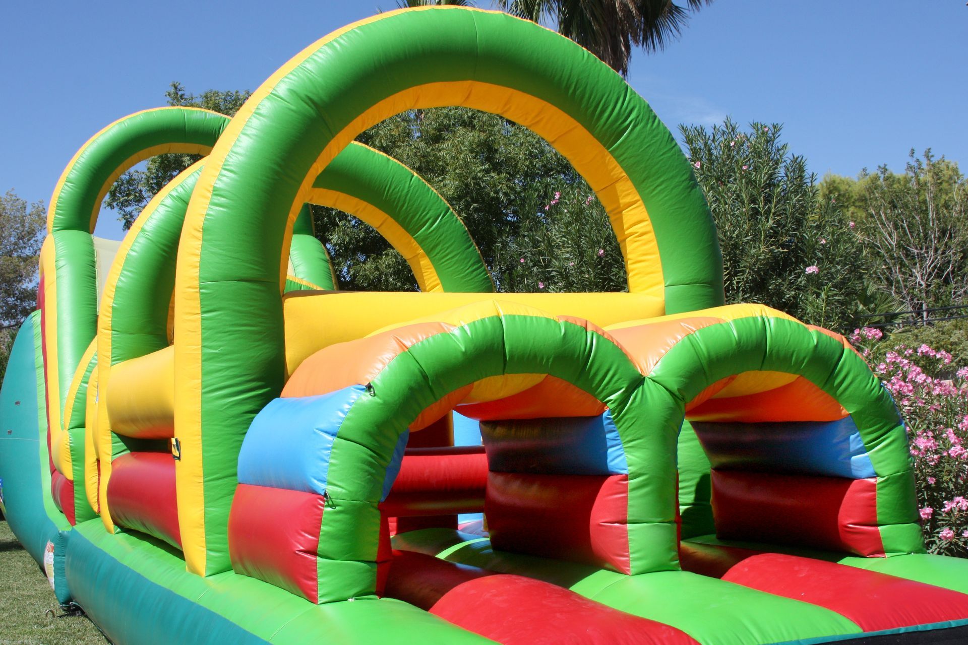 Colorful bounce house on a grassy field outdoors