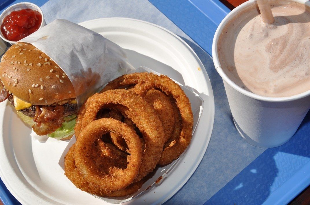 burger, onion rings and shake