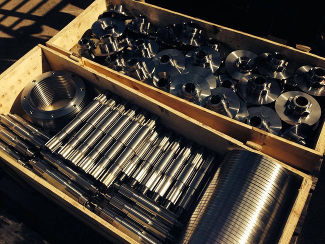 a wooden box filled with lots of metal parts