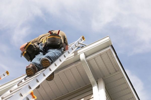 Nanaimo Handyman on a ladder completing exterior roof repairs