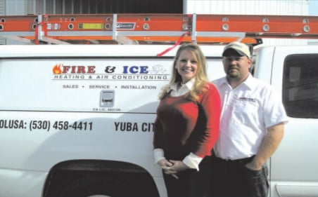 A man and woman standing in front of a fire and ice van A man and woman standing in front of a fire and ice van