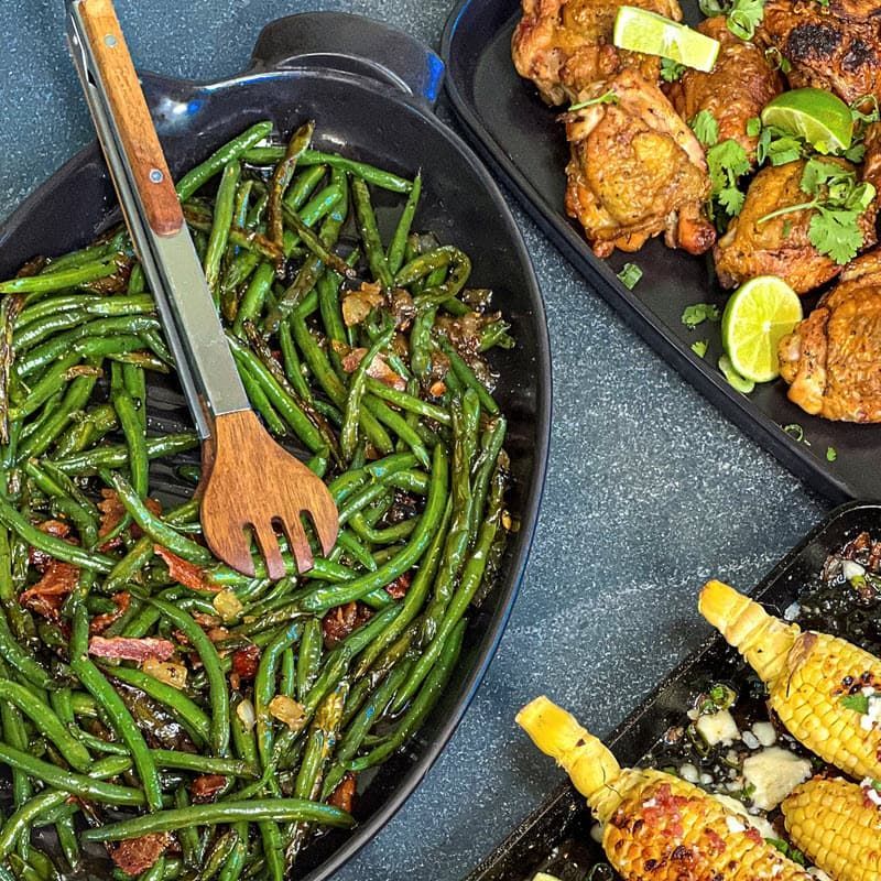 Maple smoked bacon green beans plated with chicken and corn