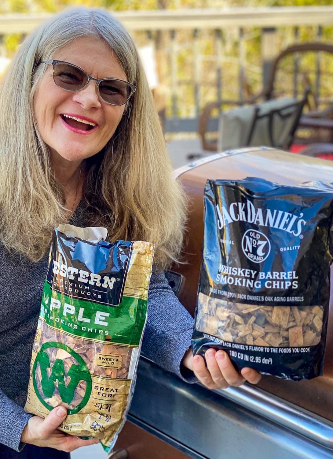 Merry Graham with Western Apple Smoking Chips bag, & Jack Daniel's Whiskey Barrel Smoking Chips Bag