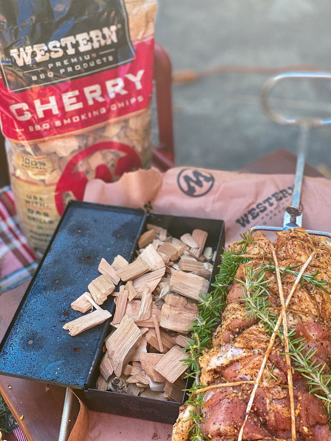 Prepped pork loin with Cherry smoking chips in smoking box