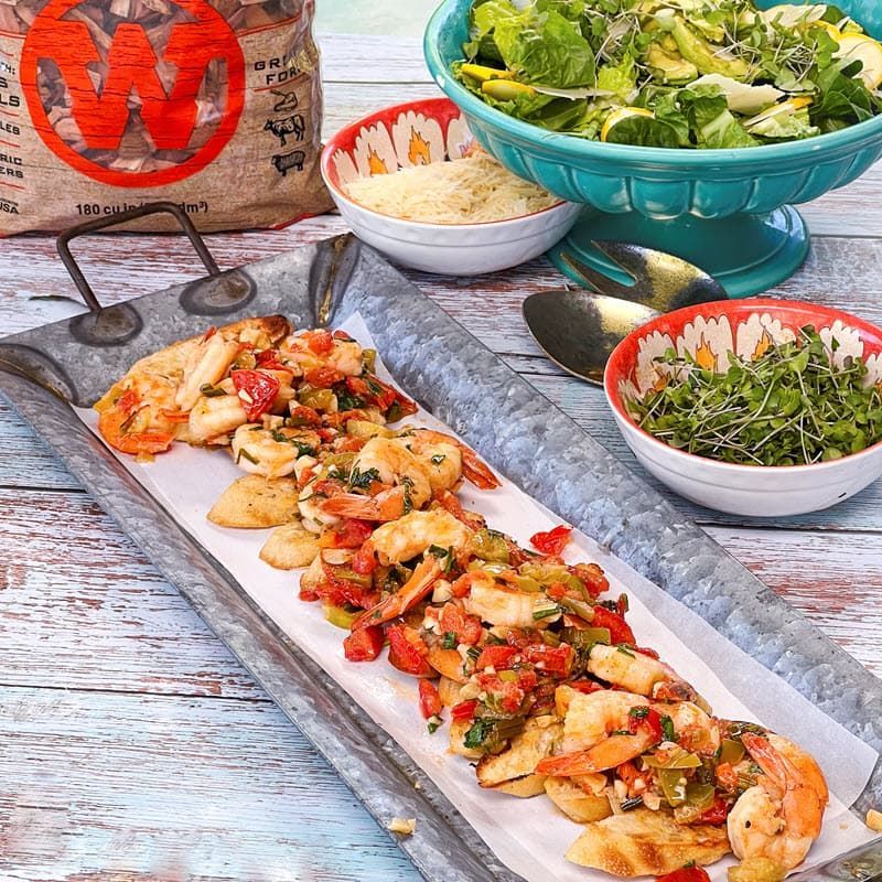 shrimp scampi bruschetta plated with Western mesquite chips, salad and grated parmesan