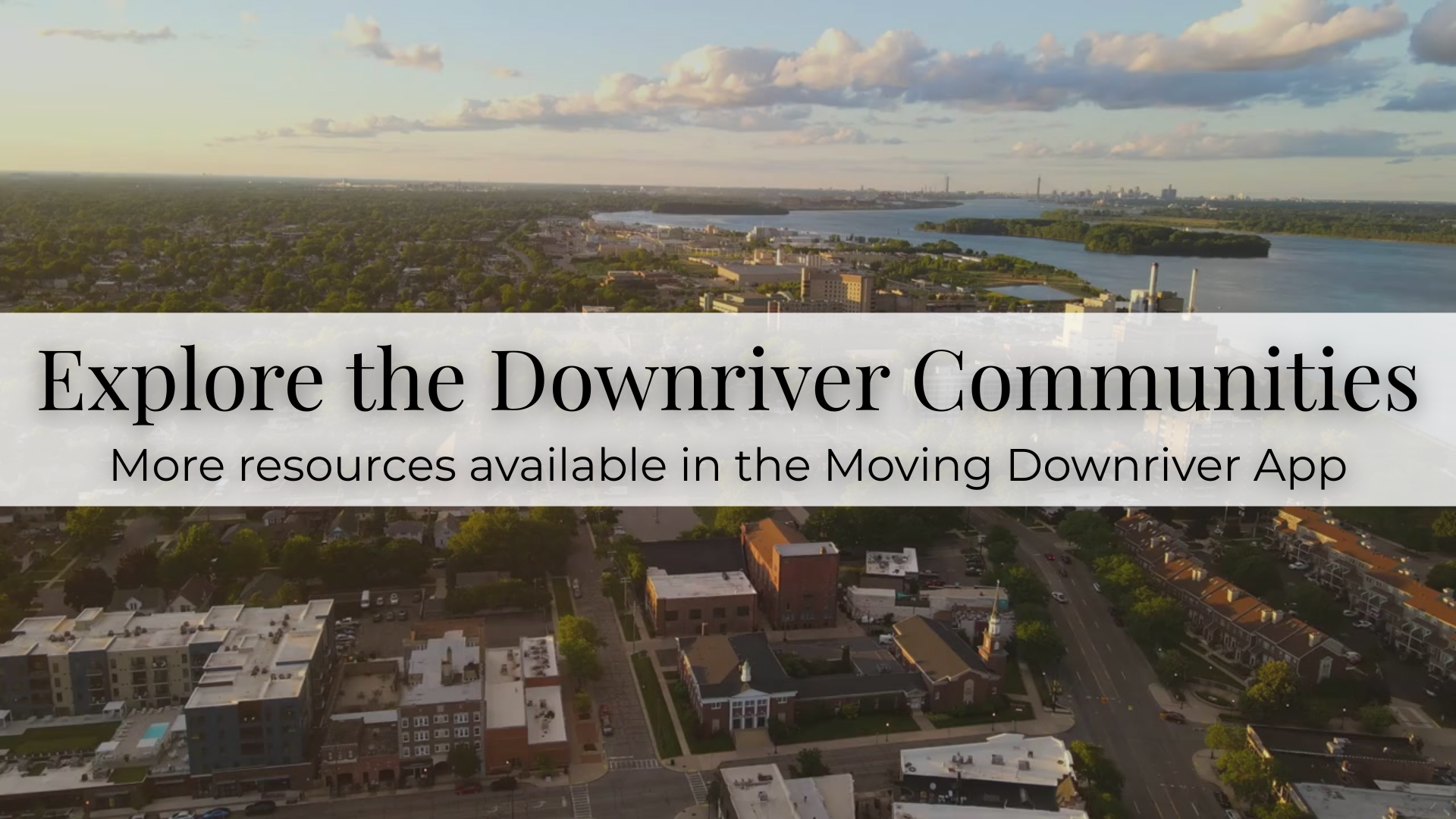 Aerial view of a riverfront town with banner text: “Explore the Downriver Communities” and app promotion.