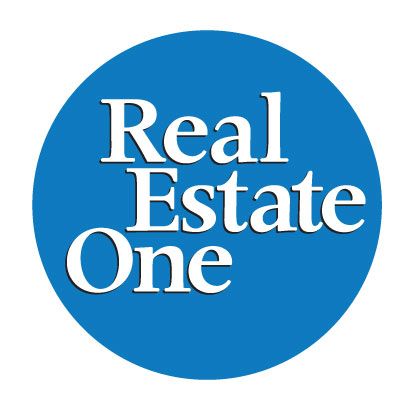 Real Estate One logo in white text on a blue circle.