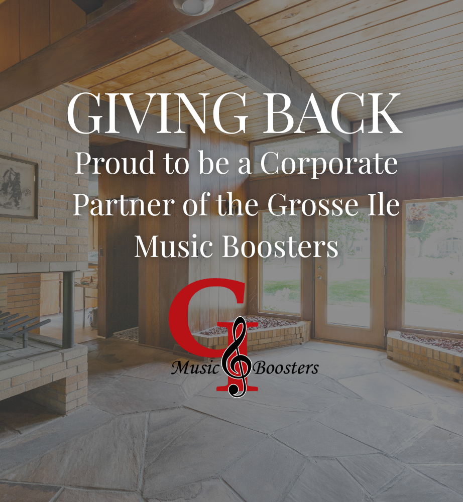 “Giving Back” sign in a bright room, saying Proud Corporate Partner of the Grosse Ile Music Boosters