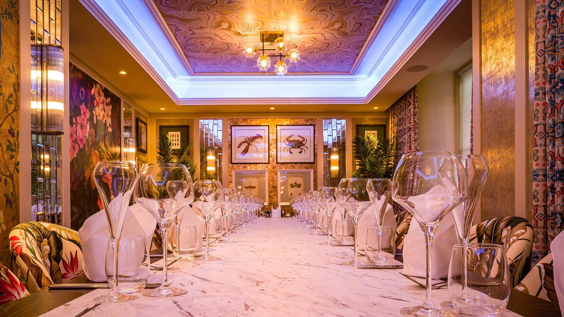 Inside The Fox and the Willow Aviary Room with 20 seats and it's marble table and gold and pictured walls