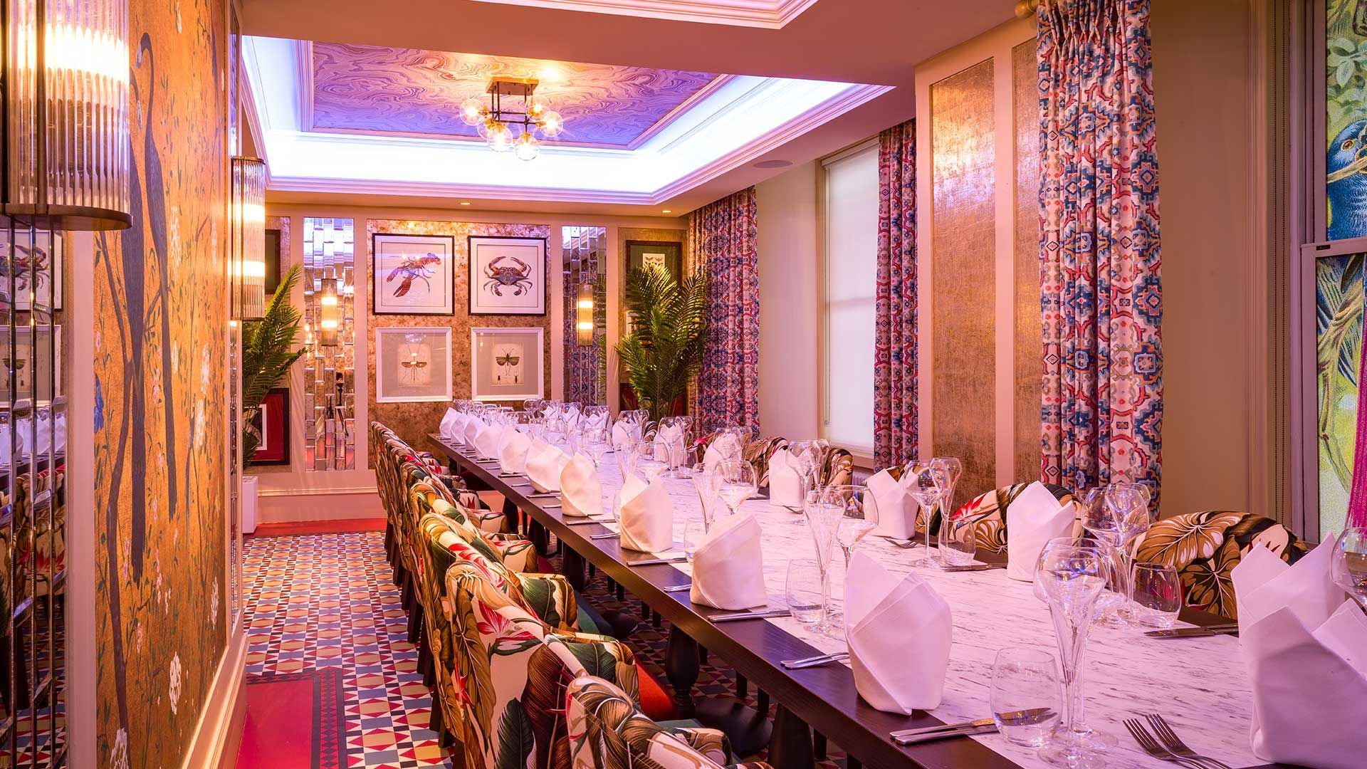 Inside The Fox and the Willow Aviary Room with 20 seats and it's marble table and gold and pictured walls