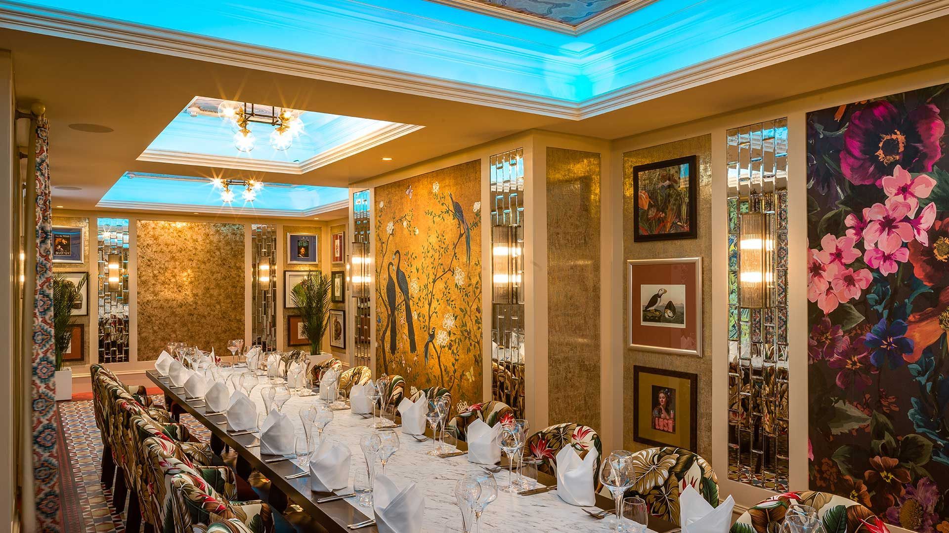 Inside The Fox and the Willow Aviary Room with 20 seats and it's marble table and gold and pictured walls