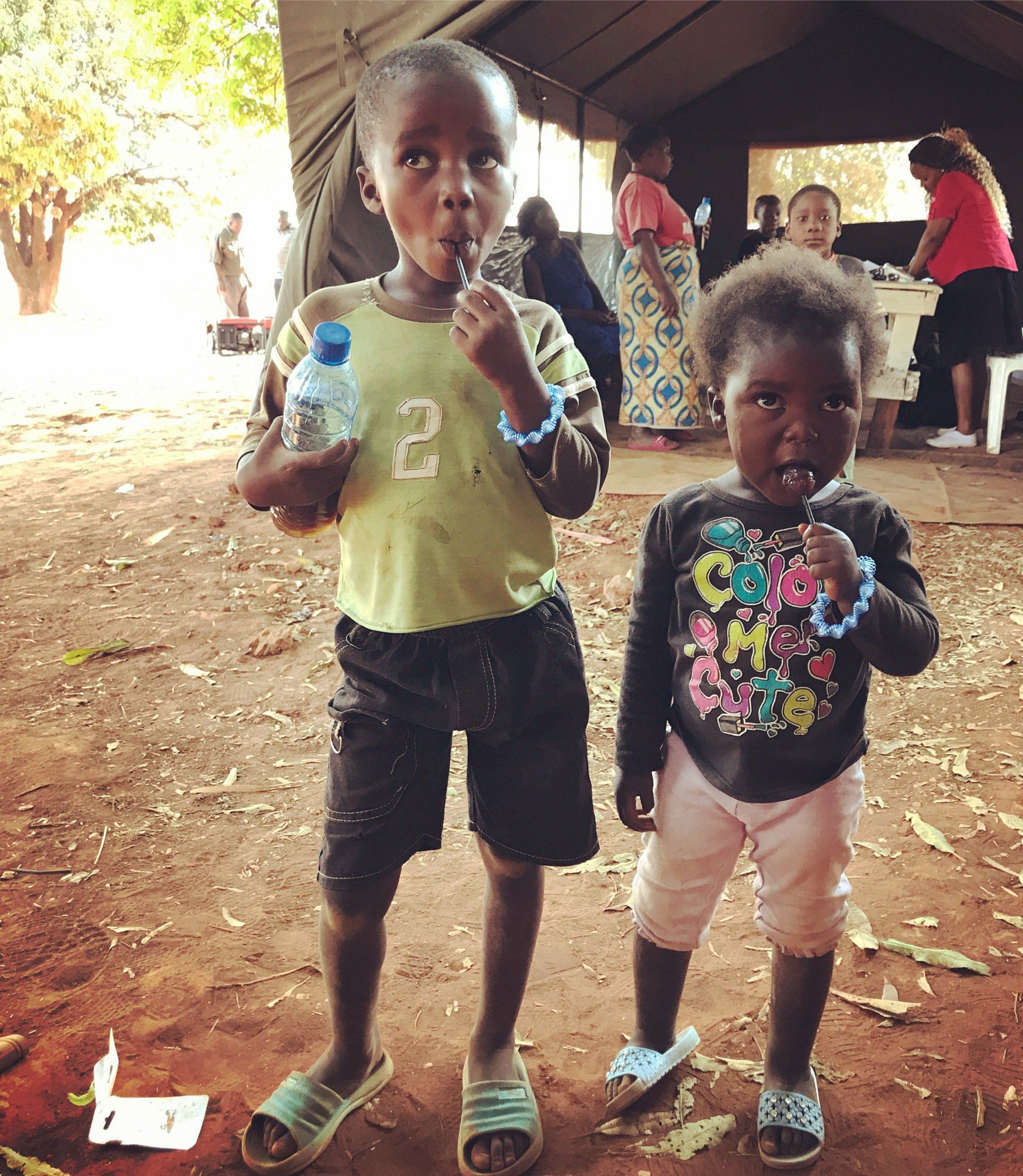 A boy with the number 2 on his shirt stands next to a girl